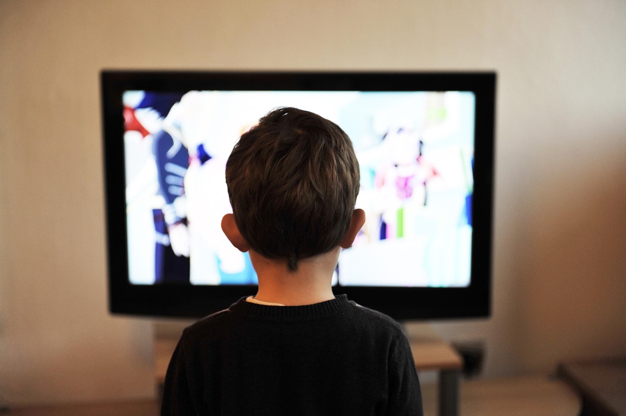 family watching smart tv at night